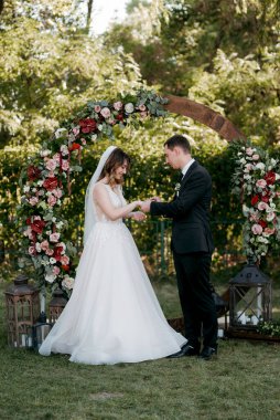 wedding ceremony of the newlyweds on the glade near the restaurant