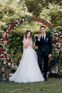wedding ceremony of the newlyweds on the glade near the restaurant