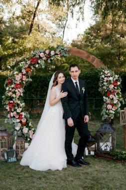 wedding ceremony of the newlyweds on the glade near the restaurant