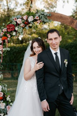 wedding ceremony of the newlyweds on the glade near the restaurant