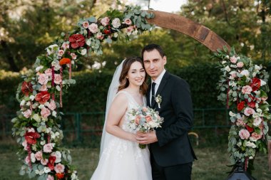 wedding ceremony of the newlyweds on the glade near the restaurant