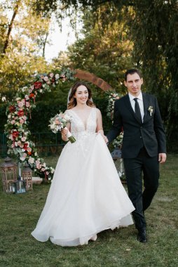 wedding ceremony of the newlyweds on the glade near the restaurant
