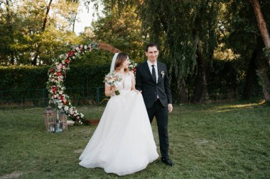 wedding ceremony of the newlyweds on the glade near the restaurant
