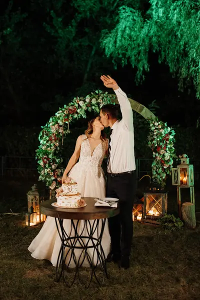 newlyweds happily cut, laugh and taste the wedding cake