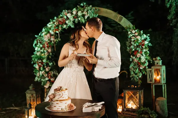 newlyweds happily cut, laugh and taste the wedding cake