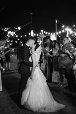 newlyweds at a wedding in the corridor of sparklers