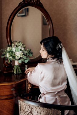 morning of the bride with the creation of the image of makeup and the creation of hairstyles