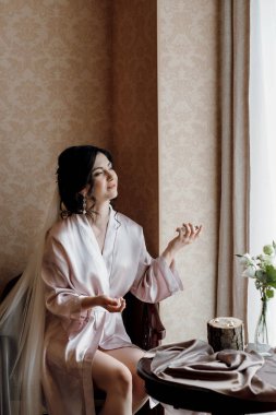 morning of the bride with the creation of the image of makeup and the creation of hairstyles