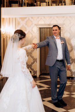 Gelin ve damadın ilk düğün dansı gün batımında restoranın içinde.