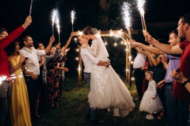 Pasta mumlarından ve havai fişeklerden çıkan soğuk ateş yeni evlilerin ellerindeydi.