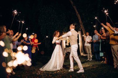 newlyweds at a wedding in the corridor of sparklers