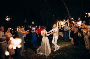newlyweds at a wedding in the corridor of sparklers