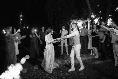 newlyweds at a wedding in the corridor of sparklers