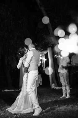 newlyweds at a wedding in the corridor of sparklers