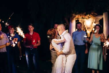 newlyweds at a wedding in the corridor of sparklers