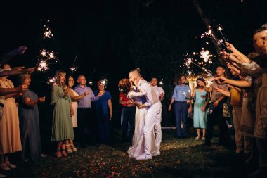 newlyweds at a wedding in the corridor of sparklers
