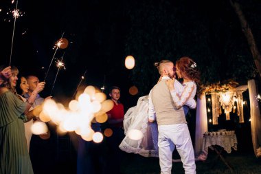 newlyweds at a wedding in the corridor of sparklers