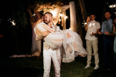 newlyweds at a wedding in the corridor of sparklers