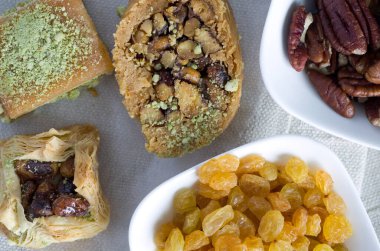Macro Image of Delicious Lebanese Desserts with Yellow Raisins and Walnut Bowls on Cloth Horizontal