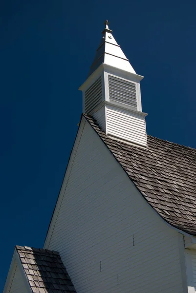 White Church Tower on Blue Sky Background Vertical