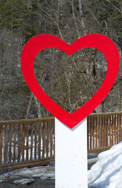 Red Heart Wood Sign at a Tourist Destination in Winter Vertical