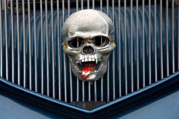 Scary Human Skull with Red Tongue on Car Front Grill Horizontal