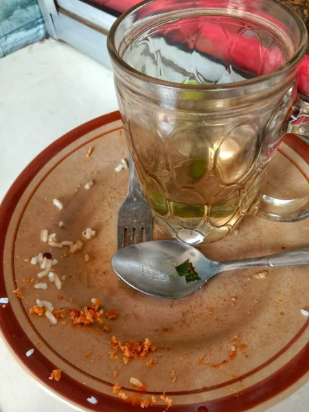dirty plates and glasses on the dining table