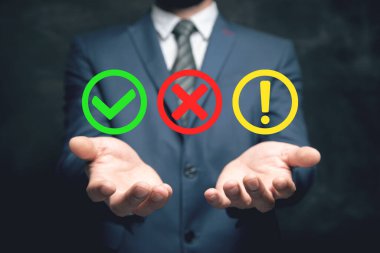 Düz yuvarlak kontrol işareti, ünlem işareti, X işareti simgeleri, izole düğmeler. Elinde tutan adam.