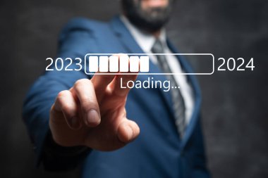 Loading from 2023 to 2024. Man tapping on the screen