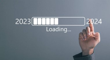 Loading from 2023 to 2024. Man tapping on the screen