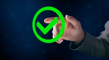 Green tick in a circle. Man tapping on the screen