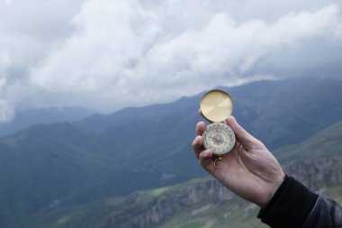 Dağın tepesindeki adamın elinde pusula. Dağın tepesinde pusula.