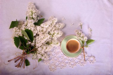 Flatlay arrangement of white lilacs in bouquet with natural string and turquoise cup with coffee.  Horizontal photo with copy space in upper right corner. Digital texture layer. clipart