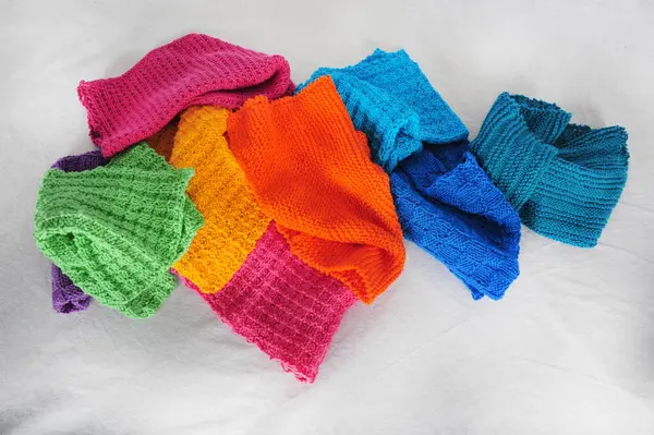 stock image Randomly arranged colorful knitted cotton dishcloths. White linen surface.  High angle top view. Copy space.