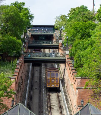 Budapeşte Kalesi Funicular demiryolu antika vagonları ve yeşil ağaçlarla çevrili yaya köprüleri, Macaristan, 4 Nisan 2024. 