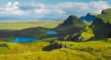 Quiraing manzarası, İskoçya 'nın Skye Adası' nın altın saat ışığında ünlü bir bakış açısı. Güzel bir yaz gününde yeşil İskoç manzarası