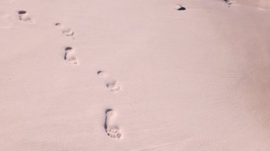 4K Gentle wave washed away the footprints on the pink sand beach