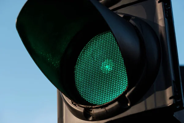 Close-up of green traffic light. Macro photo. Go forward.