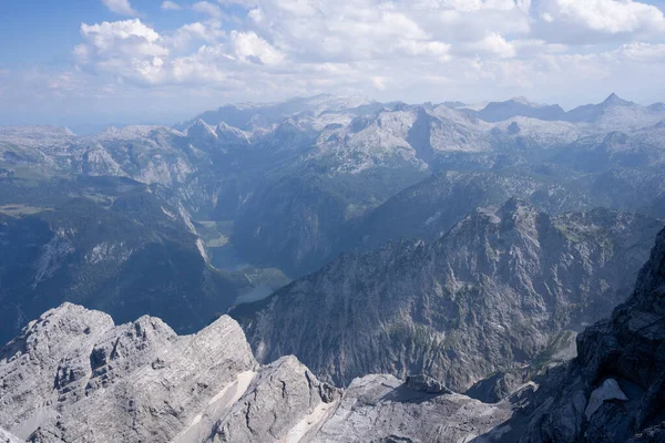 Alpine landscape with mountain ranges and lakes viewed from high mountain summit, Watzmann, Germany.
