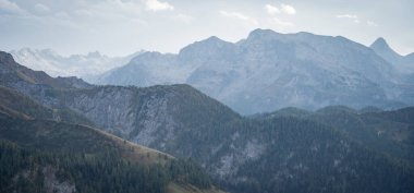 Alp manzarası dağların katmanlarıyla başlıyor. Düşük yeşillerden yüksek kayalıklara kadar..