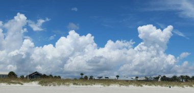 Sand dunes and beautiful clouds view on Florida beach