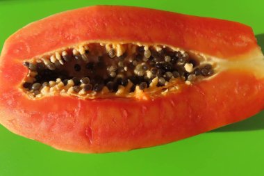 Exotic papaya fruit cut half, closeup clipart