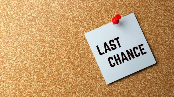 last chance - yellow note pinned on a bulletin board.