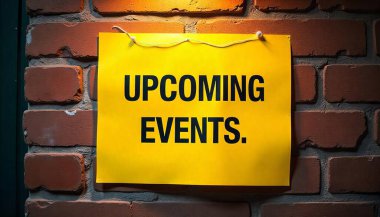 Warning sign posted on a brick wall. The sign is bright yellow with bold black text that reads Upcoming events