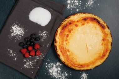 Basque cheesecake with blueberries and raspberries, copy space, overhead view. High quality photo