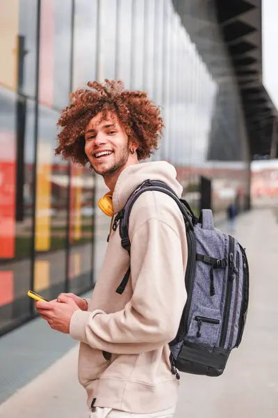 College student with curly hair smiling to the camera. Back to college. High quality photo