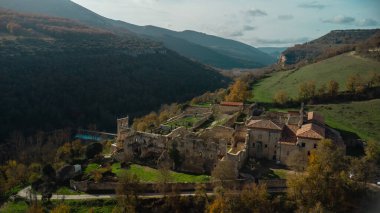 Sunlight illuminates rioseco monastery, a ruined monastery nestled in the captivating landscapes of burgos, spain clipart