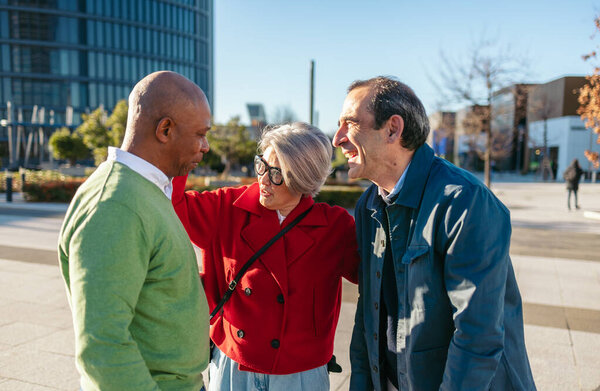 Senior companions bonding, sharing laughter while walking city street, genuine friendship showcasing connection