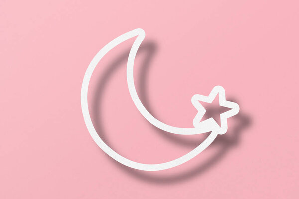 White paper cut into crescent shapes and stars set on pink paper background.