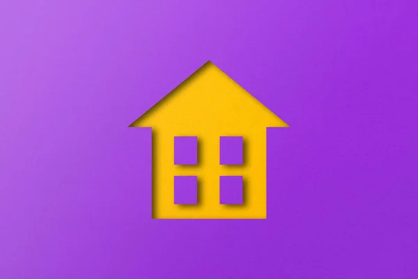 Yellow Paper Cut Out House Shape Isolated Purple Paper Background — стоковое фото